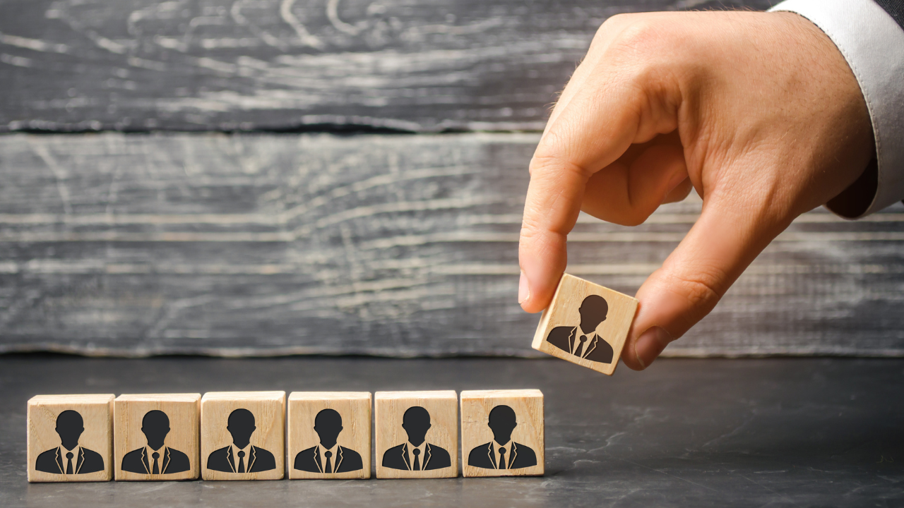The leader builds team from cubes with employees. Businessman in search of new employees and specialists. personnel selection and management within the team. removes / dismisses the employee. Image Credit: Adobe Stock Images/Andrii Yalanskyi