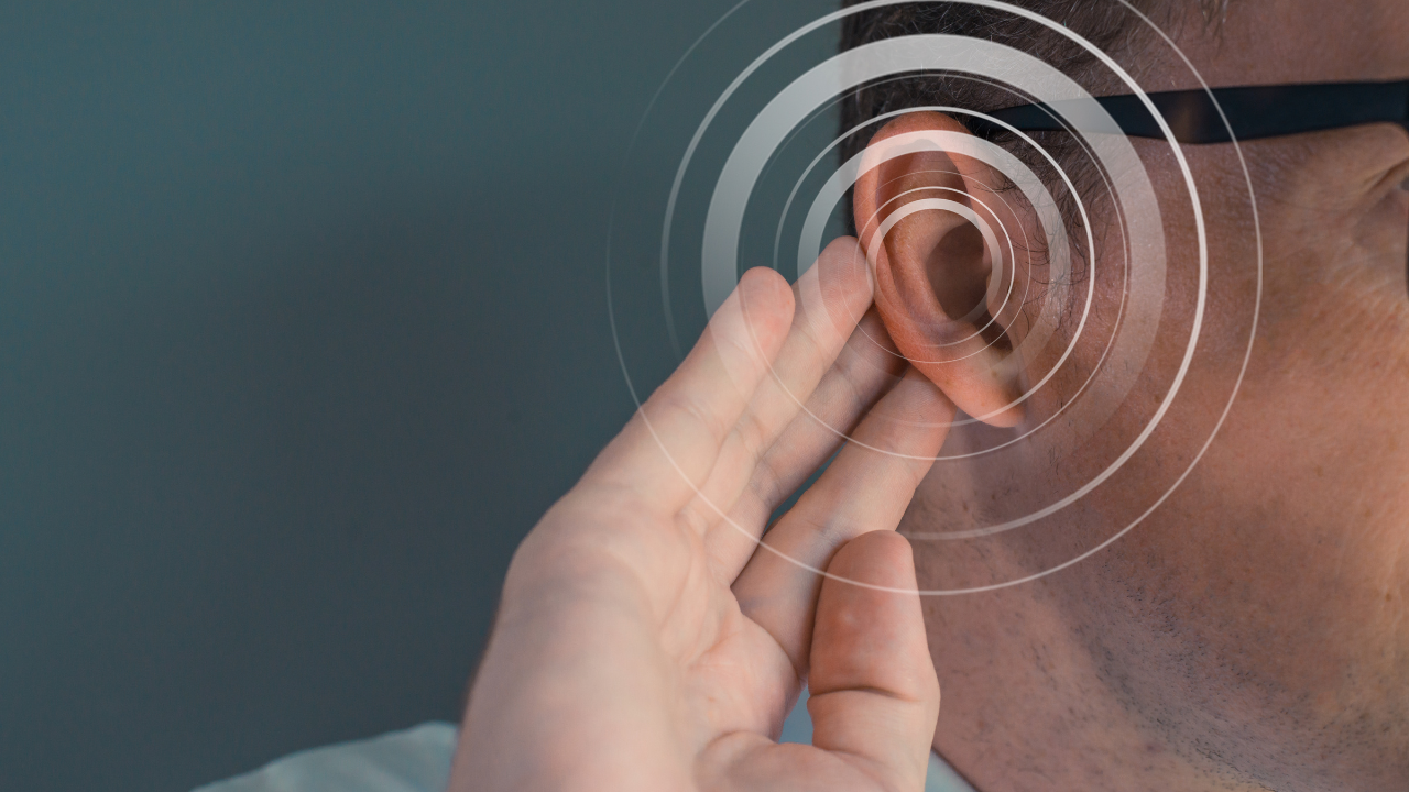 Man putting his hand on his ear. Deficiency hearing acousting problem. Empty space on the left. Image Credit: Adobe Stock Images/steph photographies